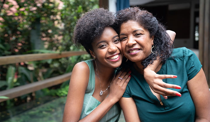 Mom and daughter smiling.