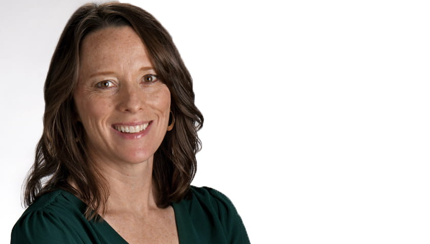 Close up image of a woman with brown hair smiling