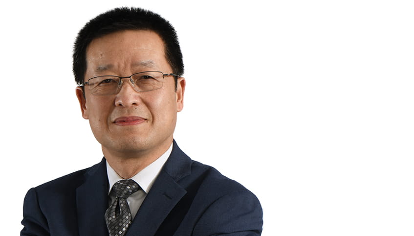 Close up of a man in glasses and a suit