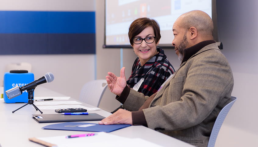 Pivot members talking at training.