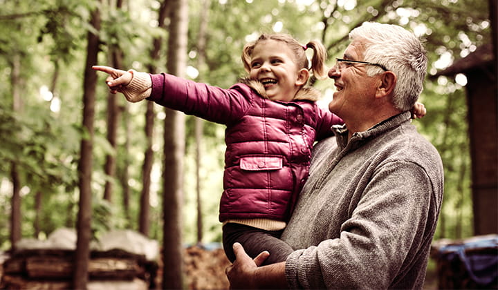 Happy man playing with child after successful pancreatic cancer treatment at KU Cancer Center.